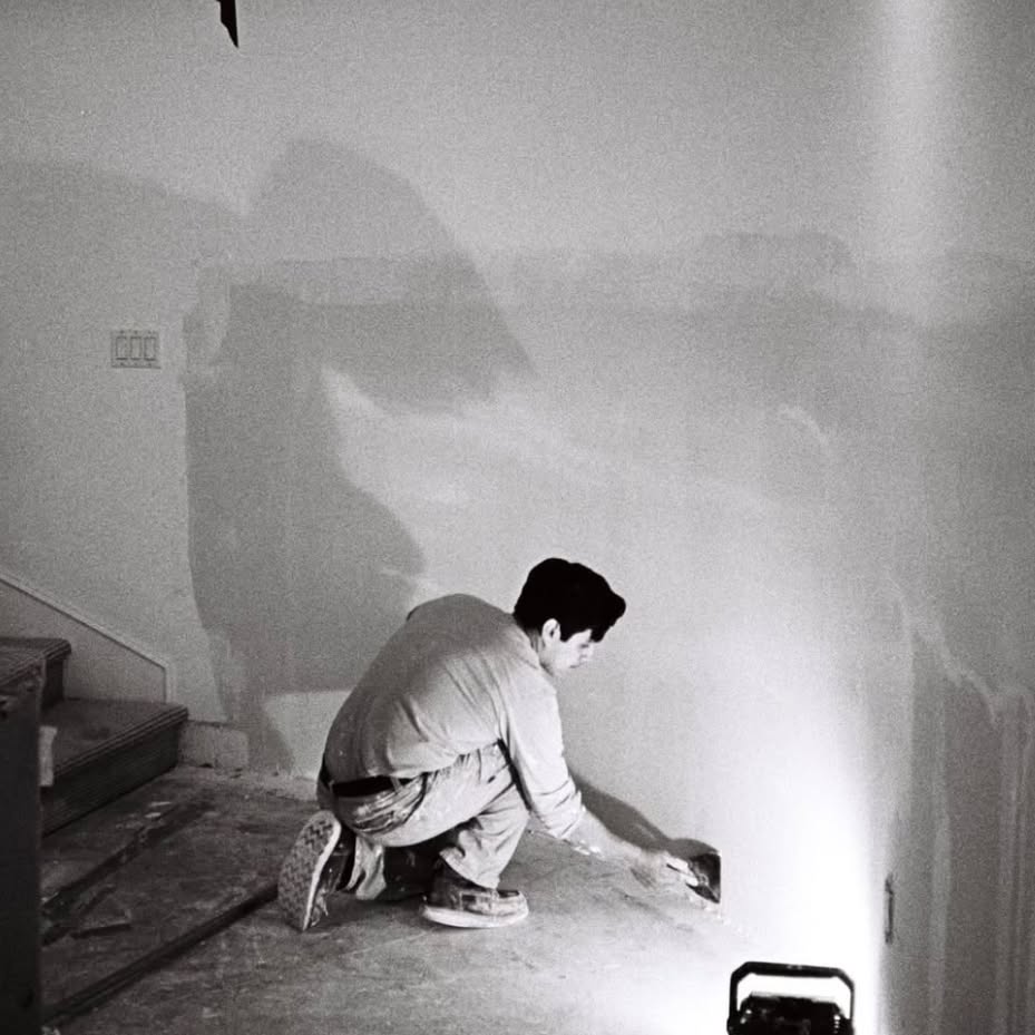 Joel Cruz finishing a drywall wall on the job