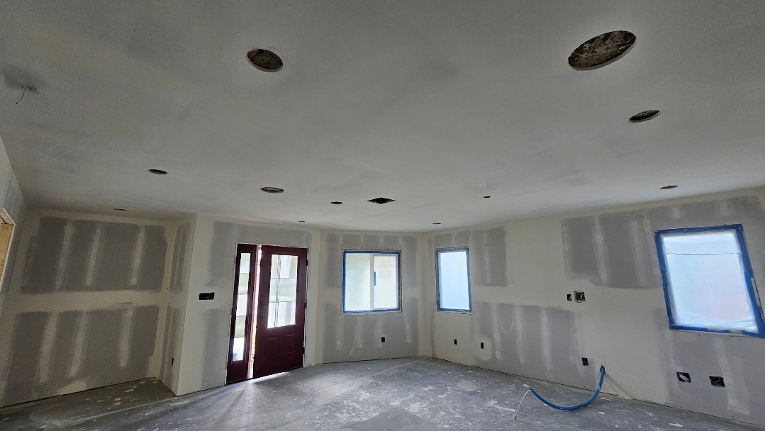 Open room with hung and taped drywall ready for finishing